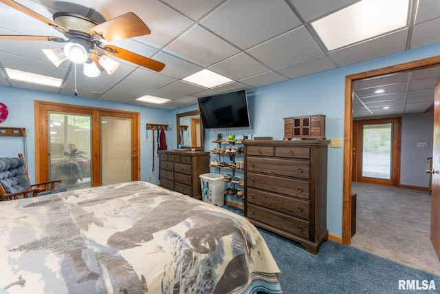 carpeted bedroom with baseboards, a paneled ceiling, and ceiling fan