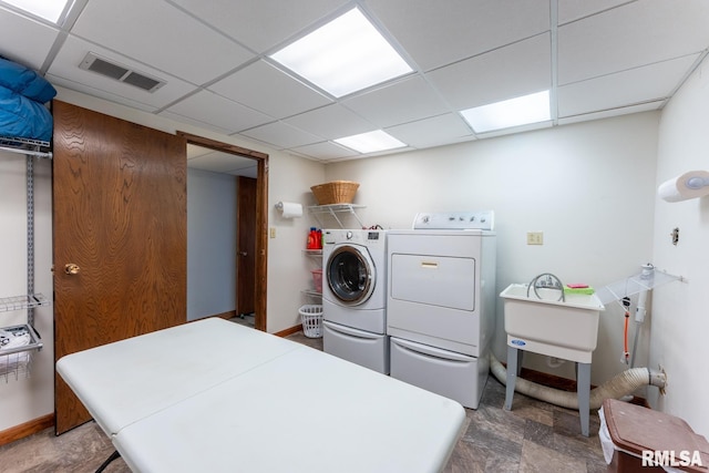 washroom with separate washer and dryer, laundry area, visible vents, and baseboards