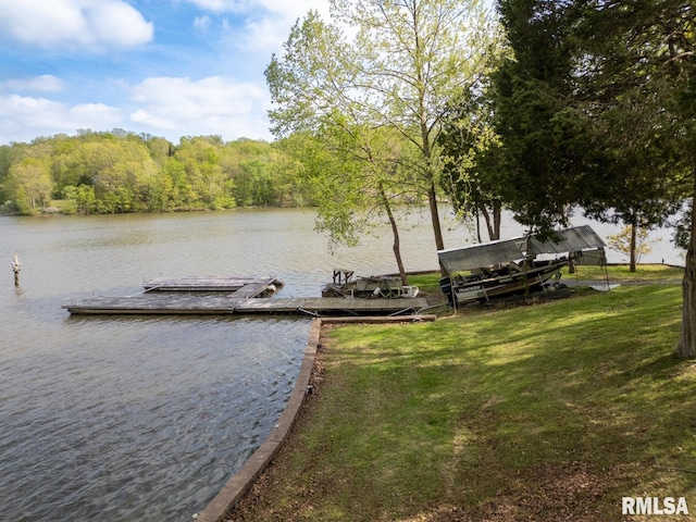 view of dock featuring a water view and a forest view