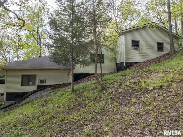 view of property exterior featuring a shingled roof