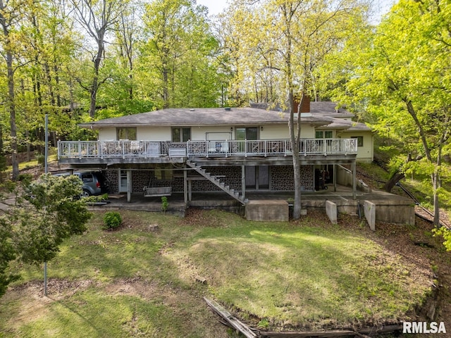 rear view of house featuring stairway, a patio, a wooden deck, and a lawn