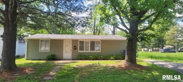 bungalow-style home with a front yard