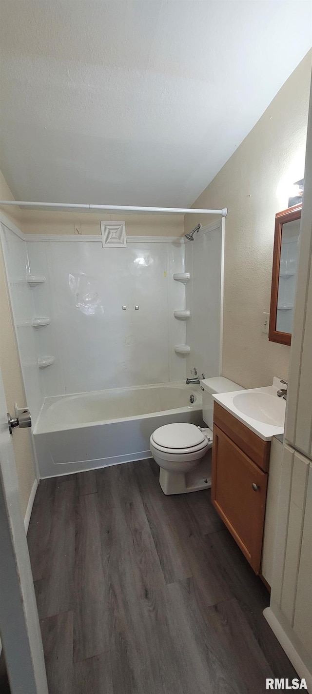 bathroom featuring visible vents, wood finished floors, vanity, toilet, and shower / bathtub combination