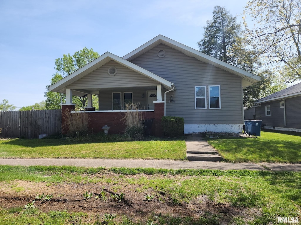 bungalow featuring fence, a porch, and a front lawn