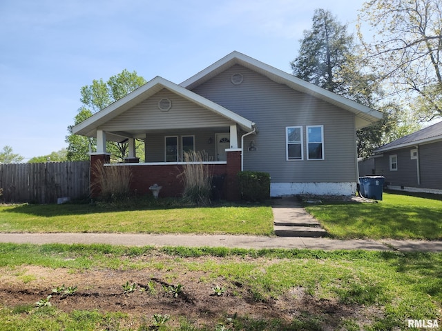 bungalow featuring fence, a porch, and a front lawn
