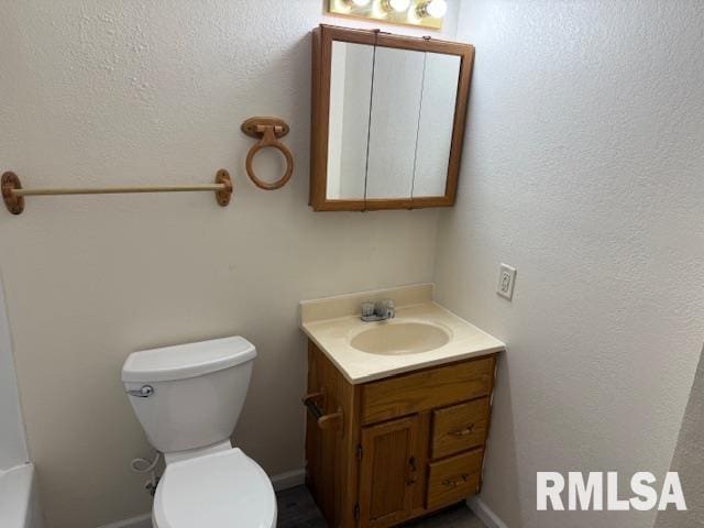 bathroom with toilet and vanity
