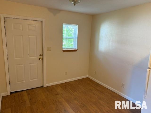 interior space featuring baseboards and wood finished floors