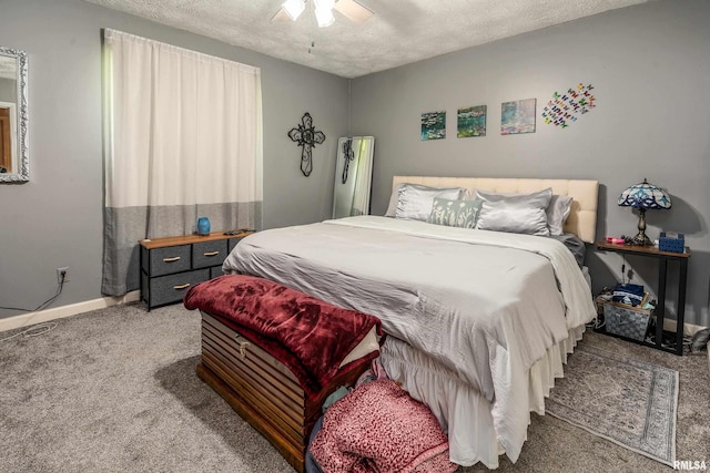 bedroom featuring a textured ceiling, baseboards, and carpet