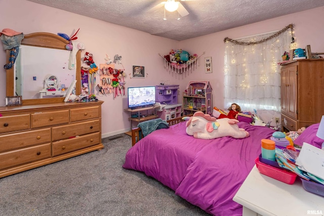 carpeted bedroom featuring ceiling fan and a textured ceiling