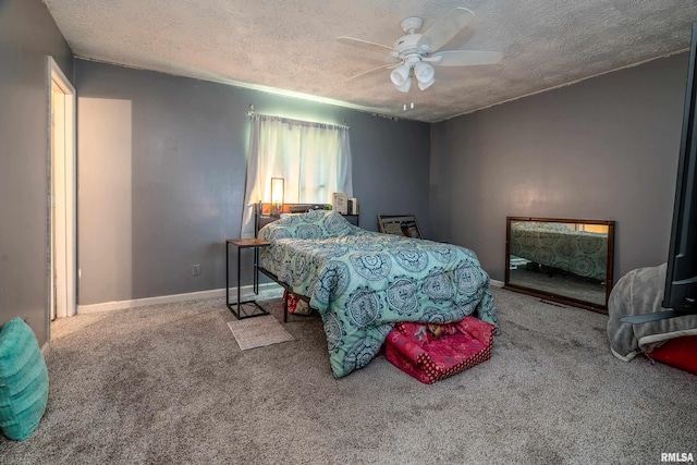 bedroom with baseboards, a ceiling fan, carpet flooring, and a textured ceiling