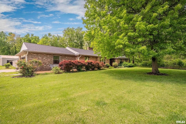 view of yard featuring an attached garage and driveway