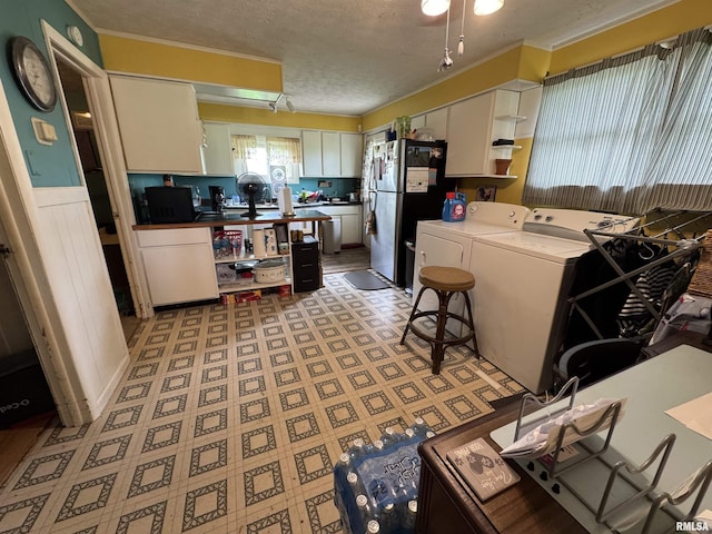 970 Beech Rd, Duquoin, IL 62832 - kitchen with washing machine and clothes dryer, open shelves, freestanding refrigerator, white cabinets, and a textured ceiling