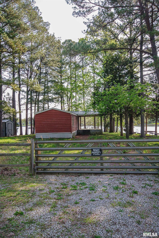 exterior space featuring fence and an outdoor structure