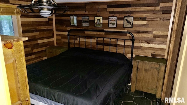 tiled bedroom featuring wood walls
