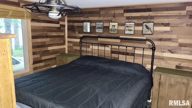 bedroom featuring wooden walls