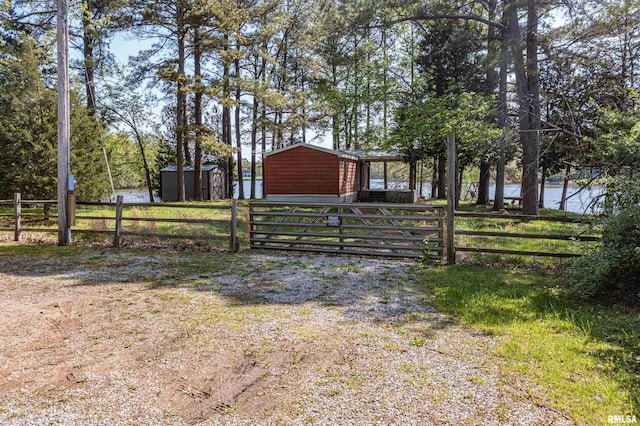 exterior space with an outdoor structure, fence, and a storage shed