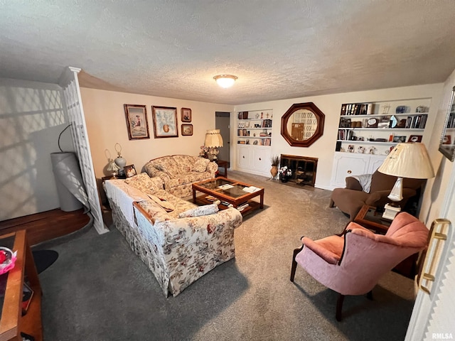 carpeted living area with a textured ceiling and built in features