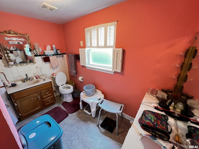 bathroom featuring visible vents, tile patterned floors, toilet, and vanity