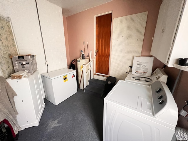 clothes washing area with water heater, laundry area, and washer and dryer