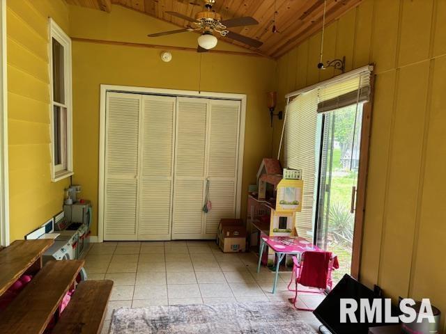 interior space with a ceiling fan and wooden ceiling
