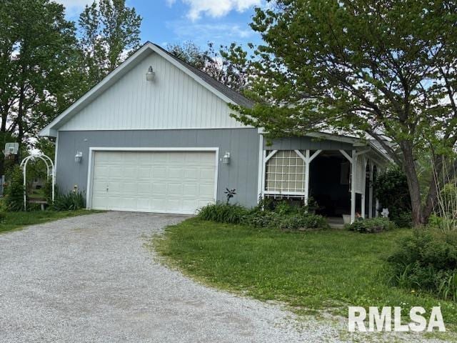 exterior space with a garage, a lawn, and driveway
