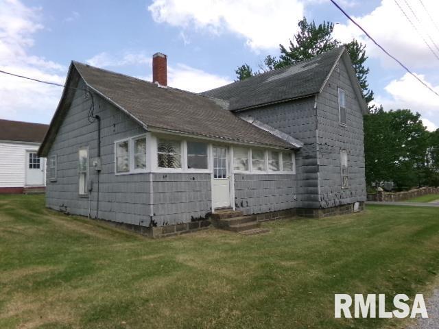 200 3rd St, Rosiclare, IL 62982 - back of property featuring roof with shingles, a chimney, and a yard