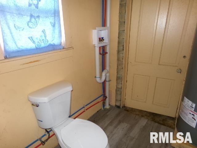 200 3rd St, Rosiclare, IL 62982 - bathroom with wood finished floors, toilet, and electric water heater