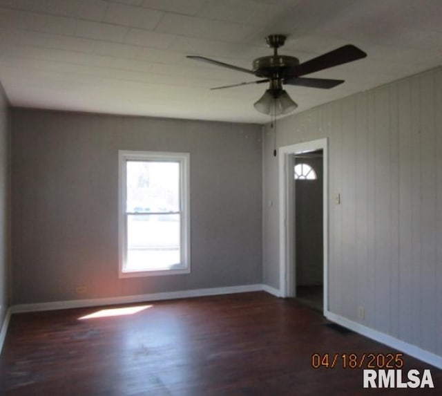 unfurnished room with baseboards, ceiling fan, and wood finished floors