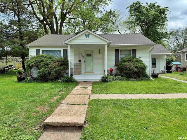 bungalow-style home featuring roof with shingles, a porch, and a front lawn