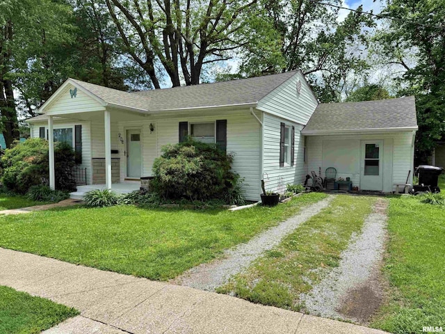view of front of house with a porch, a shingled roof, driveway, and a front yard