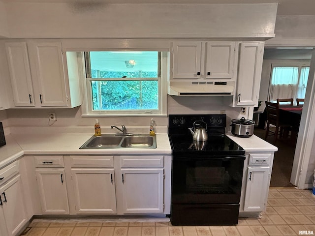206 W 16th St, Metropolis, IL 62960 - kitchen featuring electric range, under cabinet range hood, white cabinets, and light countertops