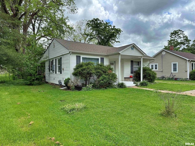 single story home featuring covered porch and a front lawn