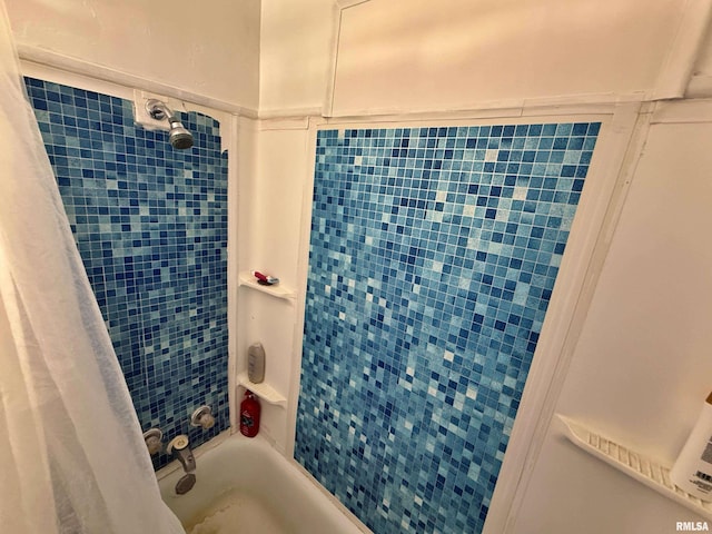 bathroom with shower / bath combo with shower curtain