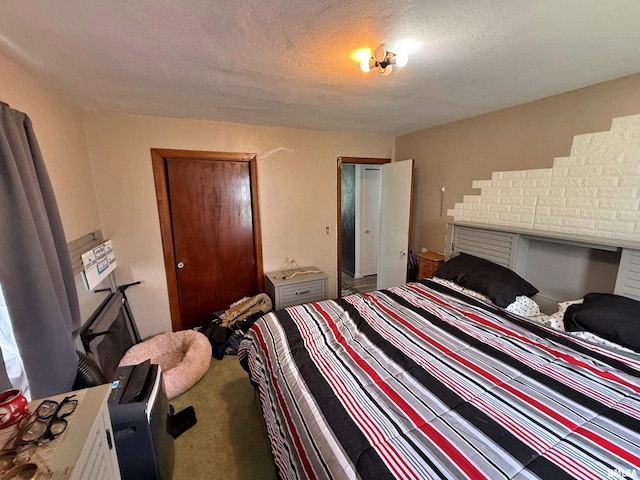 bedroom with a textured ceiling and carpet