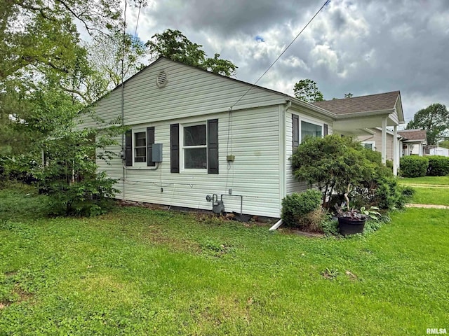 back of property featuring a yard