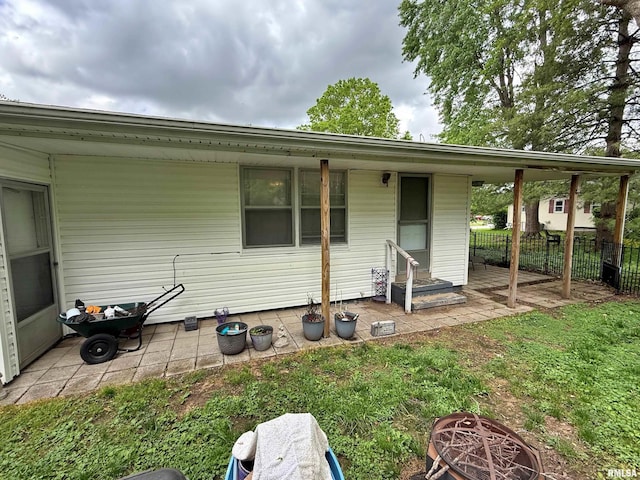 view of front of property with a patio and fence