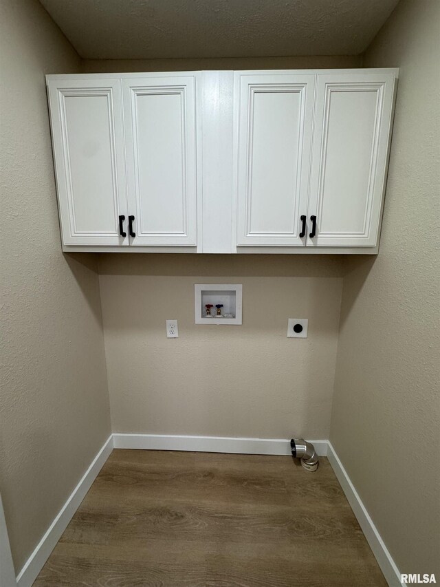 washroom with electric dryer hookup, cabinet space, baseboards, dark wood-style floors, and hookup for a washing machine