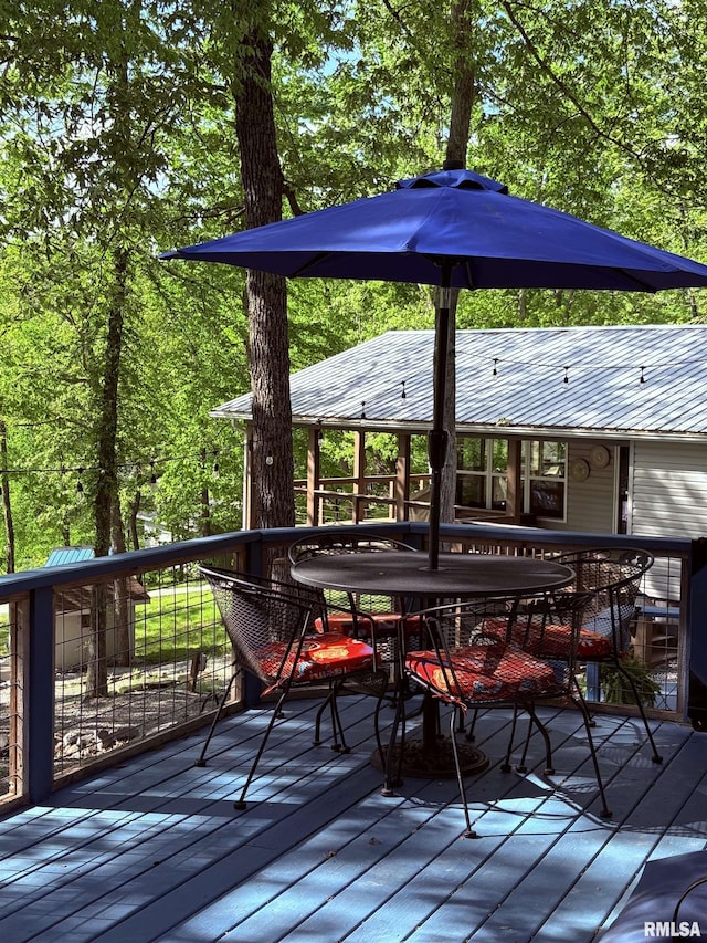 wooden deck featuring outdoor dining space