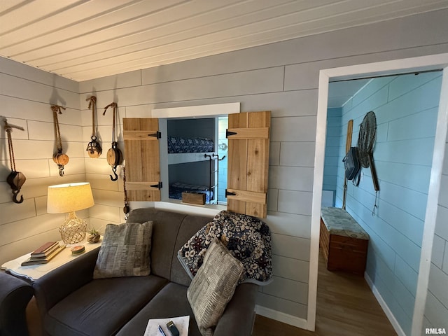living area featuring baseboards and wood finished floors