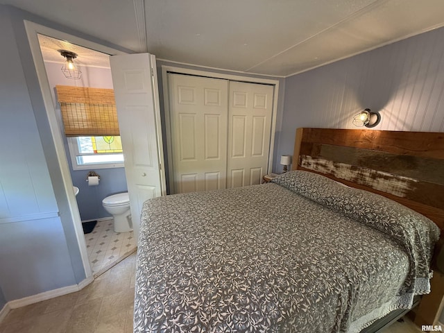 bedroom with a closet, ensuite bathroom, and tile patterned floors