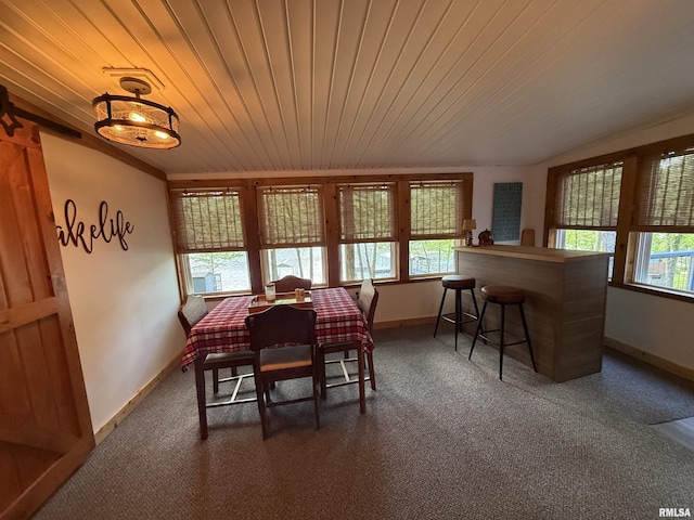 dining area with baseboards, wood ceiling, and carpet
