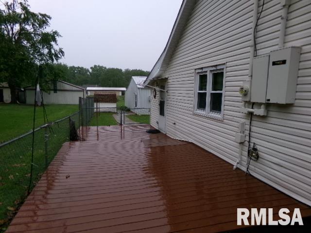 217 Trammel Rd, Carrier Mills, IL 62917 - view of side of property featuring a wooden deck, a yard, and fence