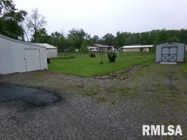 217 Trammel Rd, Carrier Mills, IL 62917 - view of yard featuring an outdoor structure and a shed