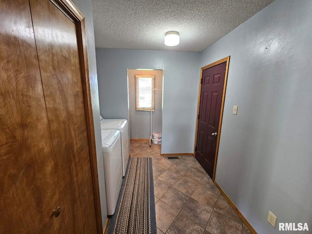 16123 N Hickory Ln, Woodlawn, IL 62898 - clothes washing area with laundry area, a textured ceiling, baseboards, dark tile patterned flooring, and washer and clothes dryer
