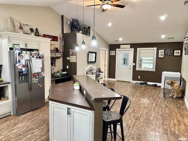 1821 Zion Hill Rd, Centralia, IL 62801 - kitchen featuring stainless steel fridge, dark countertops, a ceiling fan, vaulted ceiling, and light wood-style floors