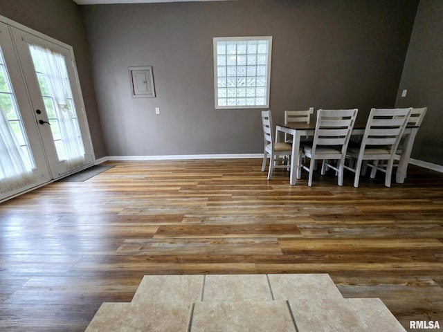 dining room with baseboards, french doors, and wood finished floors