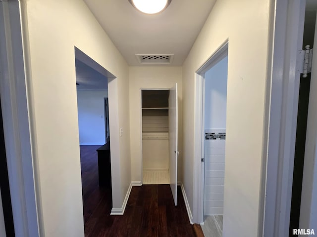 hall with visible vents and wood finished floors