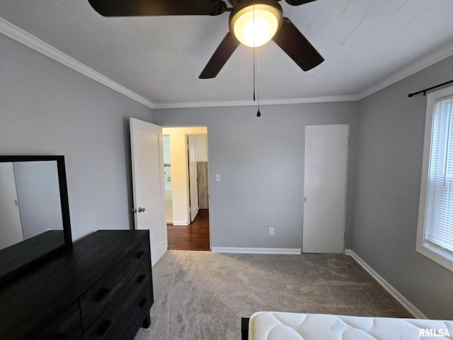 bedroom with a ceiling fan, baseboards, ornamental molding, and carpet