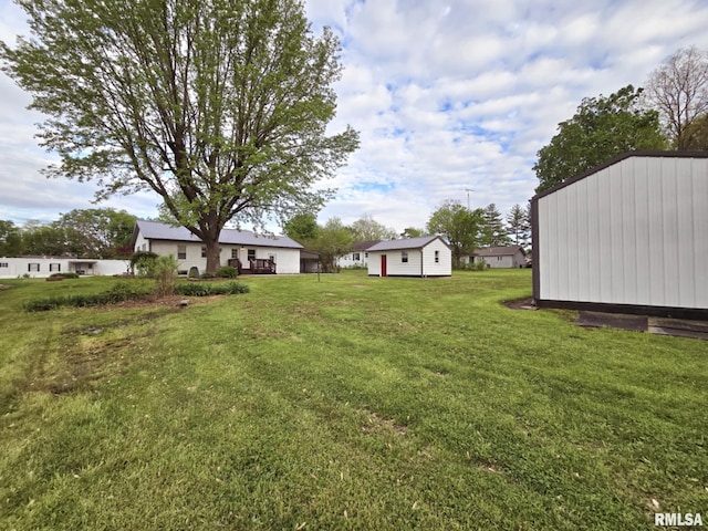 view of yard with an outdoor structure and a storage shed