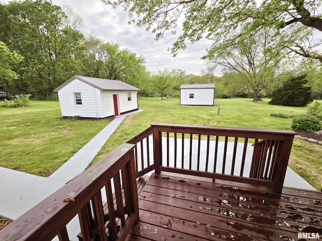 deck with a yard and an outbuilding